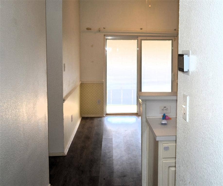 3994 Sword Dancer Way, Grand Prairie, TX 75052 Sliding glass door, wood-finish flooring, half-wall wainscoting, and white cabinetry