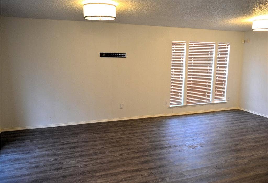 3994 Sword Dancer Way, Grand Prairie, TX 75052 Wood-finish flooring throughout, bright white walls, multiple windows with blinds, and flush mount lighting