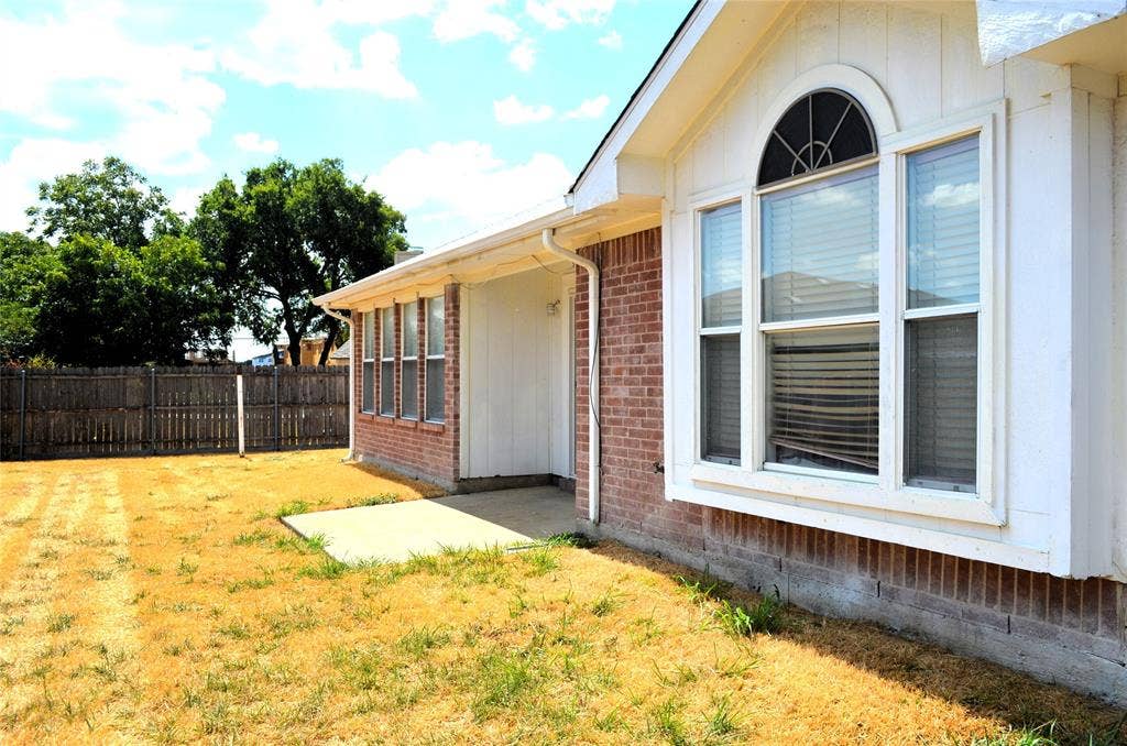 3994 Sword Dancer Way, Grand Prairie, TX 75052 Brick exterior with white trim, featuring a bay window with an arched transom