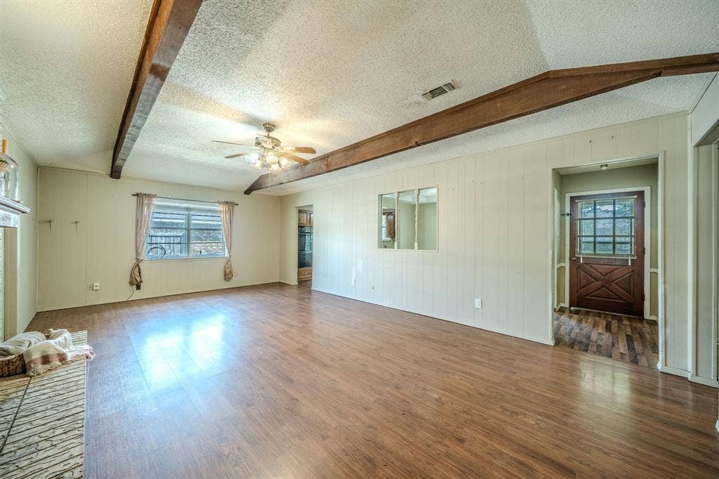 1517 Meadow Court, Midlothian, TX 76065 Exposed ceiling beams, wood-finish flooring, ceiling fan, and a built-in fireplace hearth