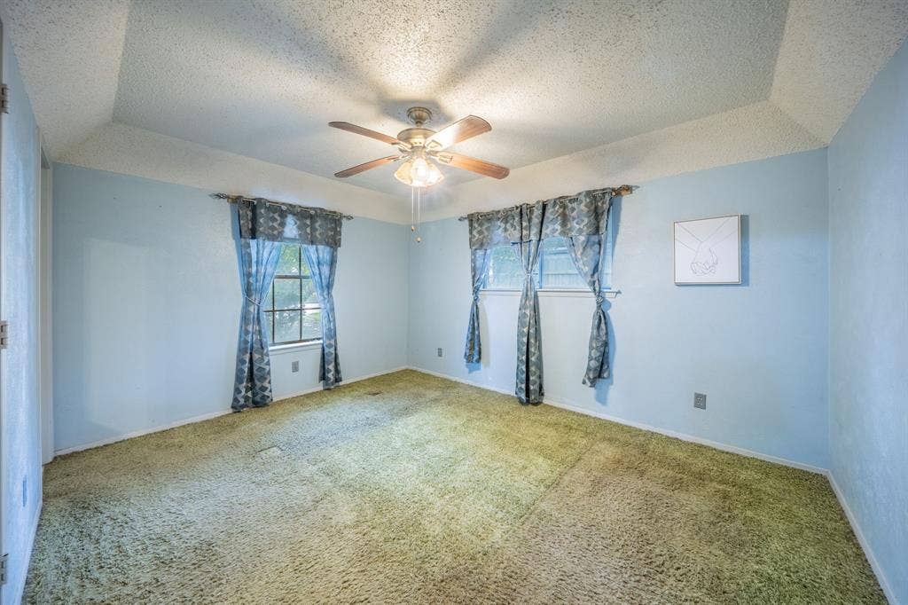1517 Meadow Court, Midlothian, TX 76065 Recessed ceiling with a central ceiling fan, and two windows