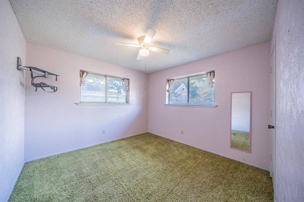1517 Meadow Court, Midlothian, TX 76065 Dual windows with exterior views, ceiling fan, and wall-mounted shelving