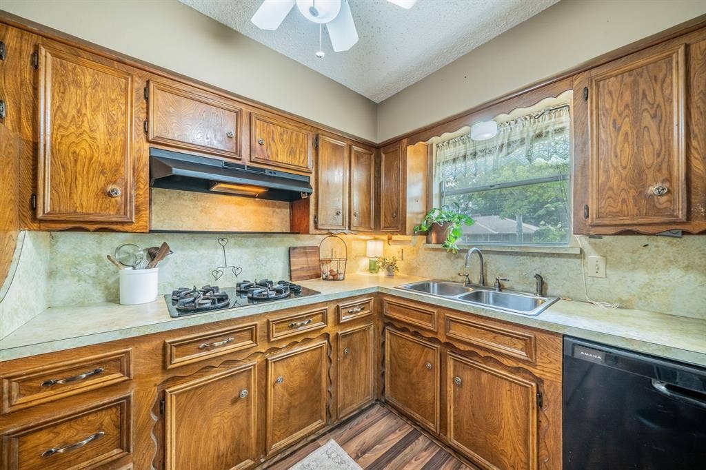 1517 Meadow Court, Midlothian, TX 76065 Wood-finish cabinetry and trim throughout the kitchen