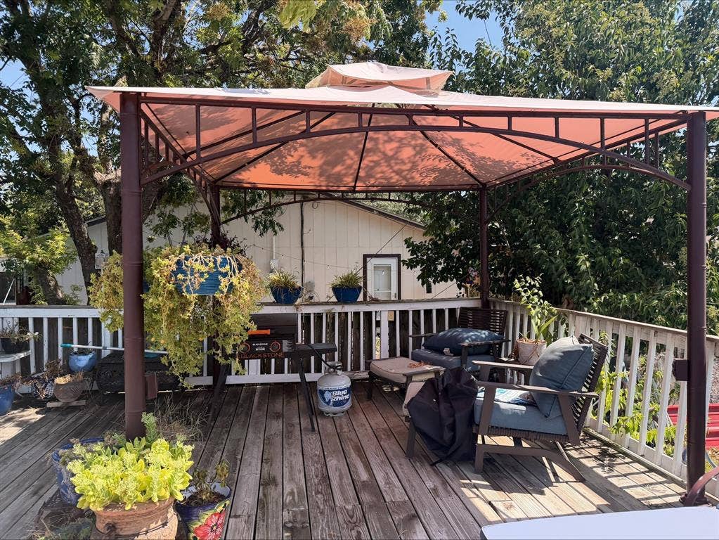 1920 Century Drive, Waco, TX 76712 Outdoor wooden deck featuring a gazebo with a fabric canopy