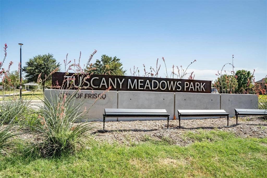 Tuscany Meadows Park signage with concrete base, metal lettering, and metal benches