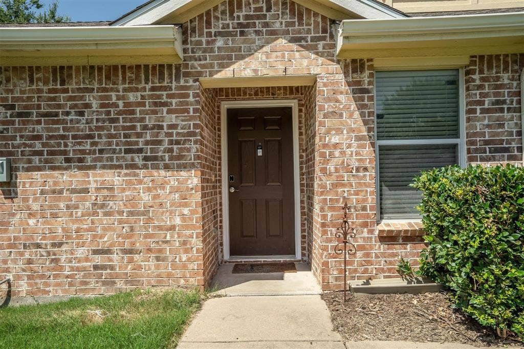 Brick exterior facade with a covered entry