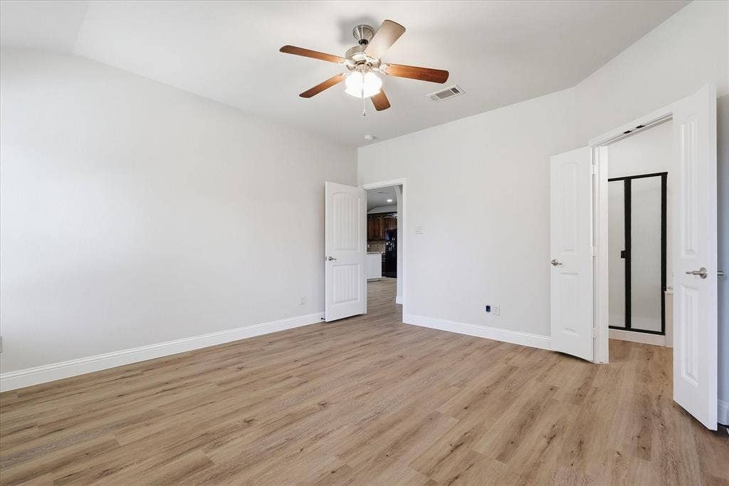 4516 Remuda Lane, Denton, TX 76226 Spacious room featuring wood-finish flooring, light-colored walls, and a ceiling fan