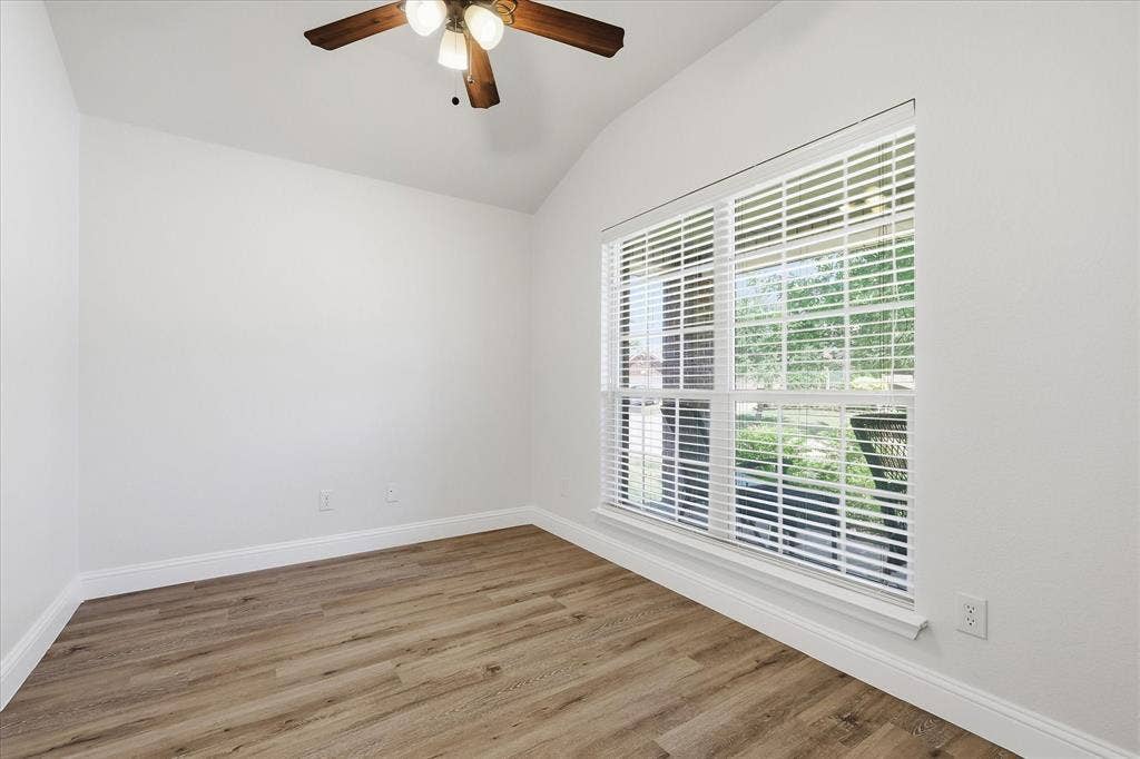 4516 Remuda Lane, Denton, TX 76226 Vaulted ceiling, ceiling fan with light fixture, wood-finish flooring, white walls, and a window with blinds