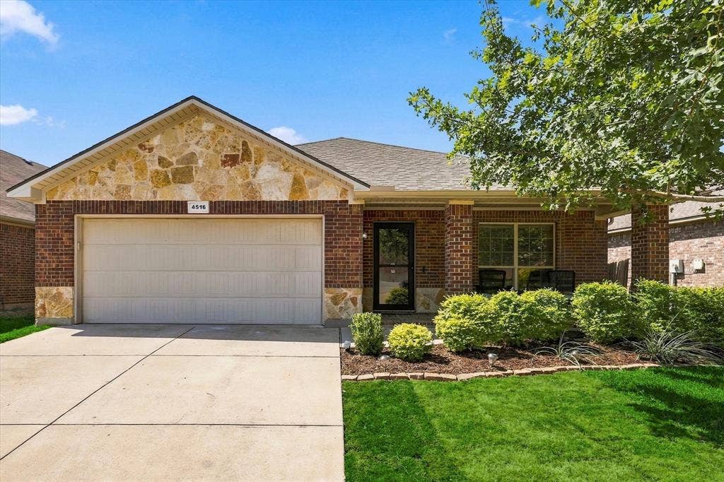 4516 Remuda Lane, Denton, TX 76226 Brick and stone veneer exterior with an attached garage