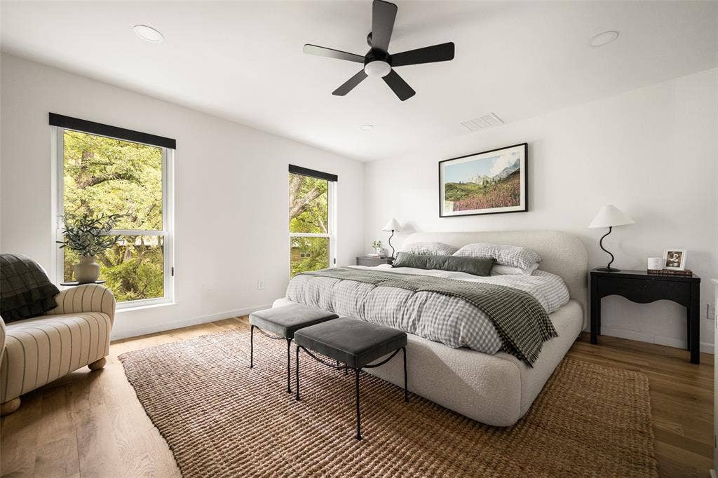 Recessed lighting, wood-finish flooring, and a ceiling fan with integrated lighting