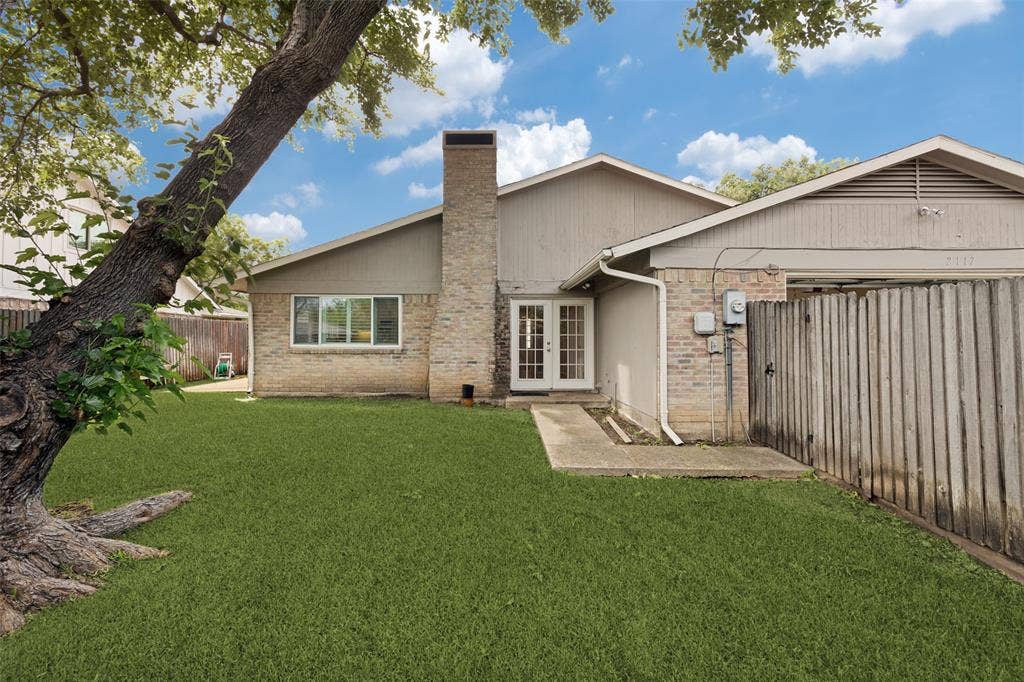 2117 Oak Brook Drive, Richardson, TX 75081 Large fenced backyard with shade tree and sprinkler system.