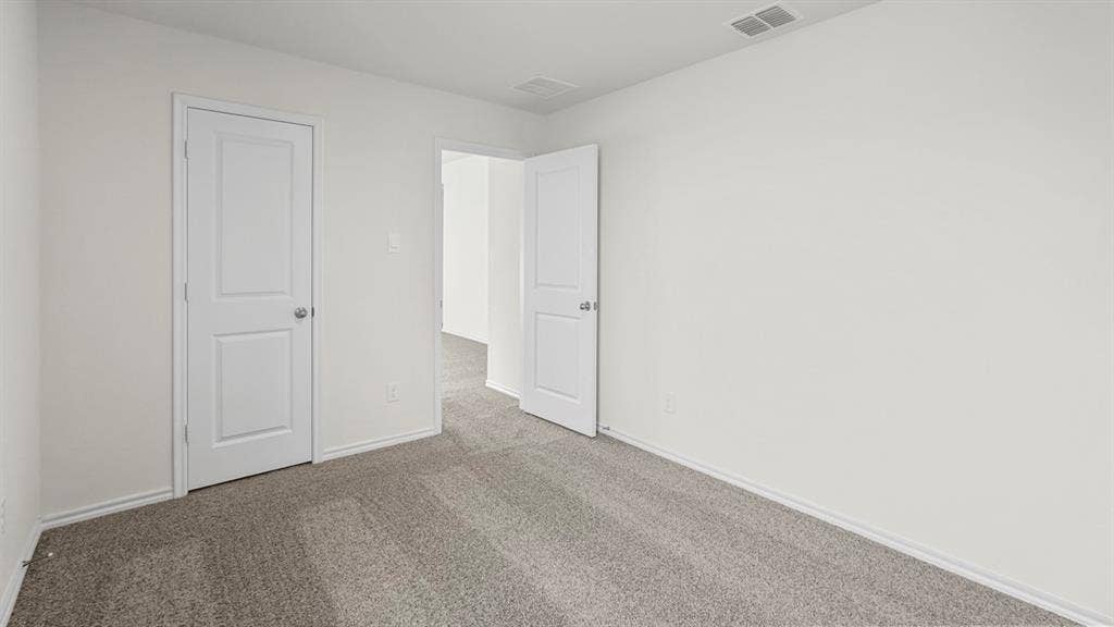 Room featuring light gray carpet flooring and white painted walls