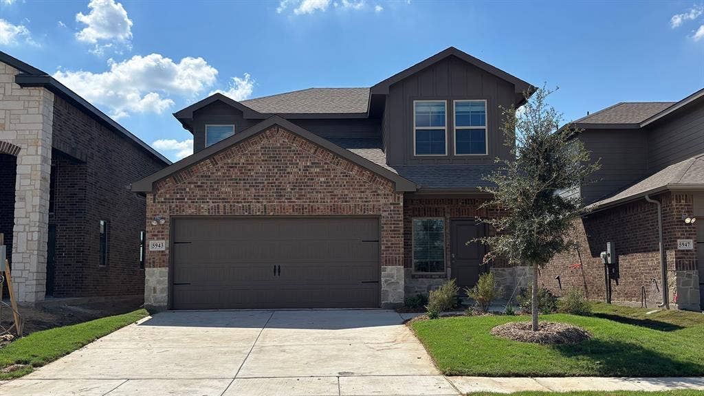 Brick and stone exterior with a two-car garage