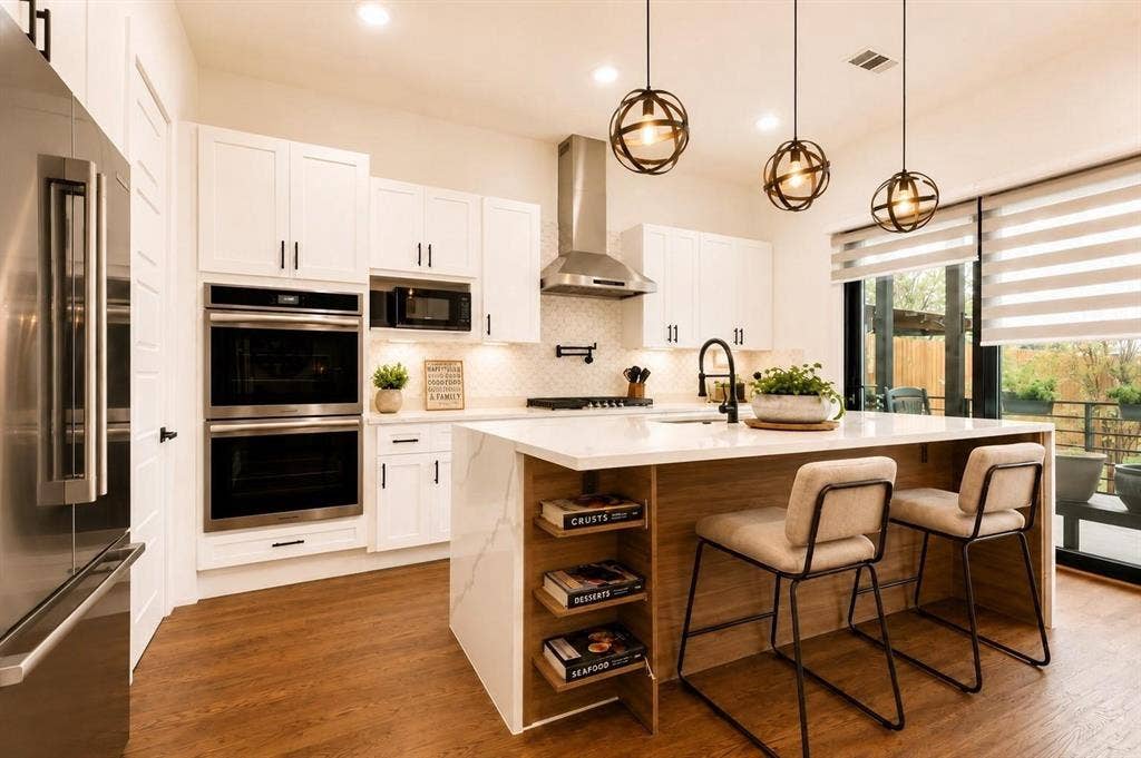 713 Wayne Street, Dallas, TX 75223 Modern kitchen featuring white shaker cabinetry, stainless steel appliances, a center island with seating, wood-finish flooring, and pendant lighting