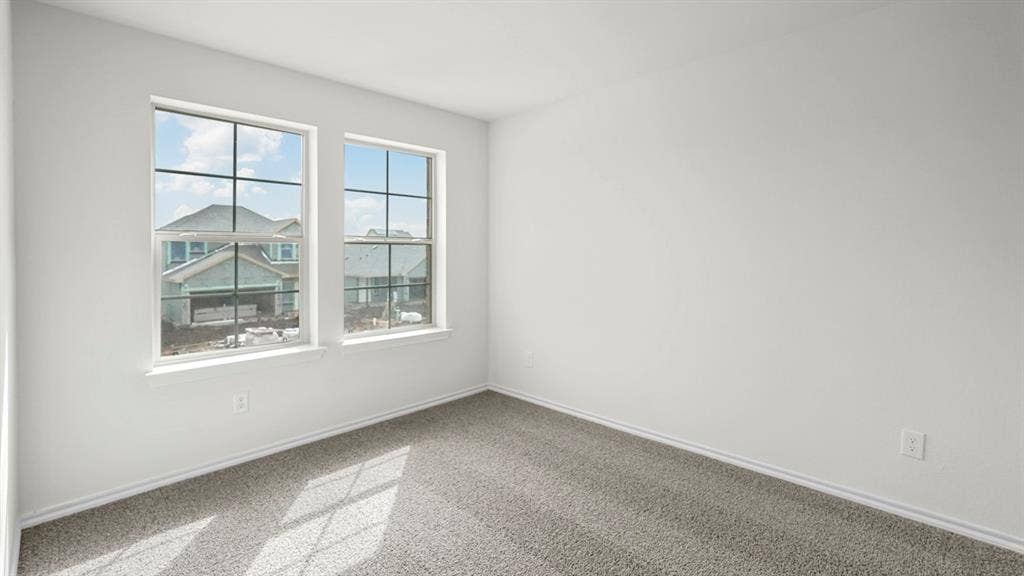 5606 Gannet Place, Crandall, TX 75114 Bright interior space featuring two large windows, white walls, and gray carpet