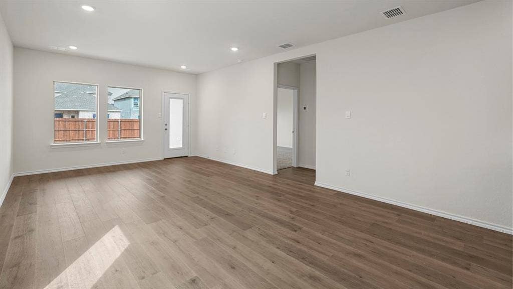 5606 Gannet Place, Crandall, TX 75114 Spacious room featuring wood-finish flooring, recessed lighting, and a neutral color palette