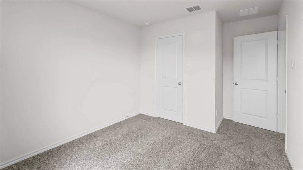 5606 Gannet Place, Crandall, TX 75114 Room featuring light gray wall-to-wall carpeting, white baseboards, and two paneled interior doors