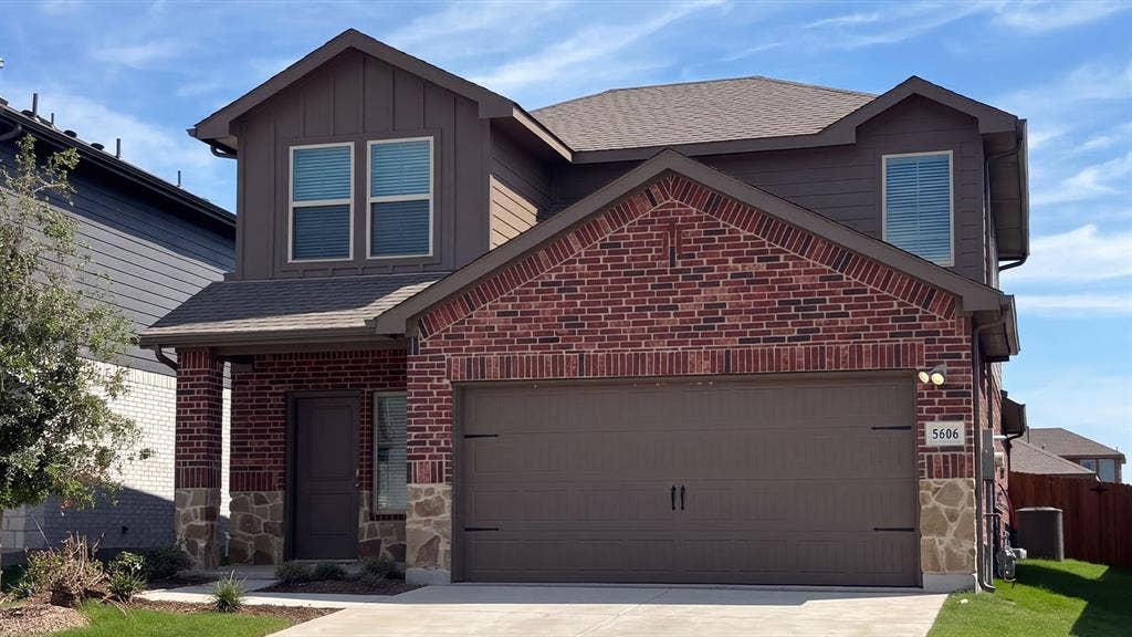 5606 Gannet Place, Crandall, TX 75114 Brick and stone facade with board-and-batten siding