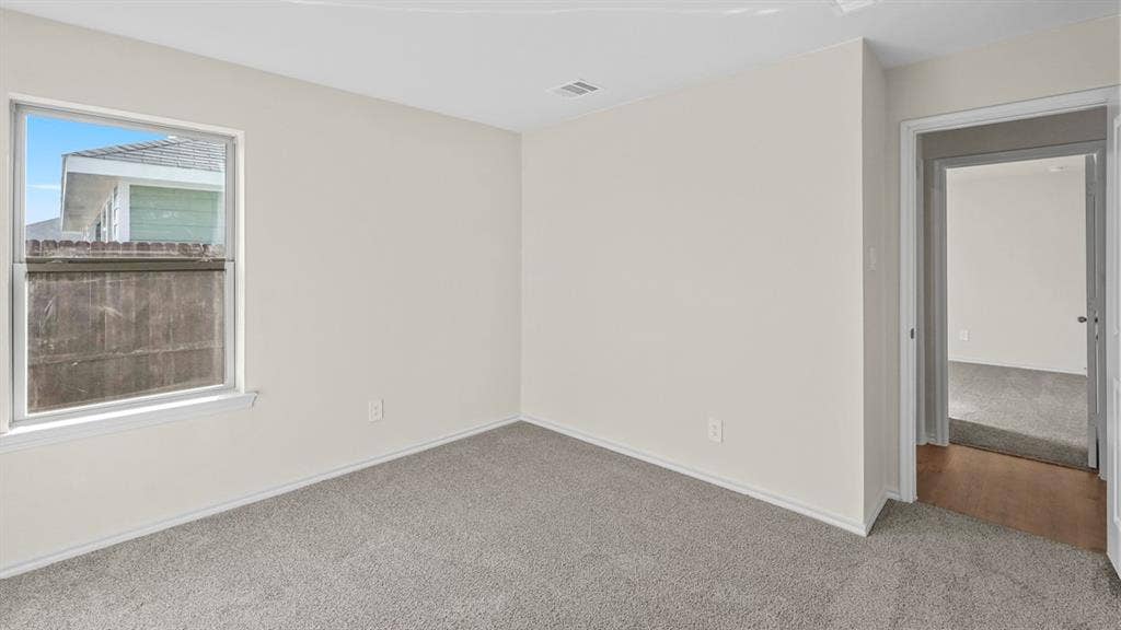 227 Whispering Pine Drive, Royse City, TX 75189 Carpeted room with a single window and neutral wall tones