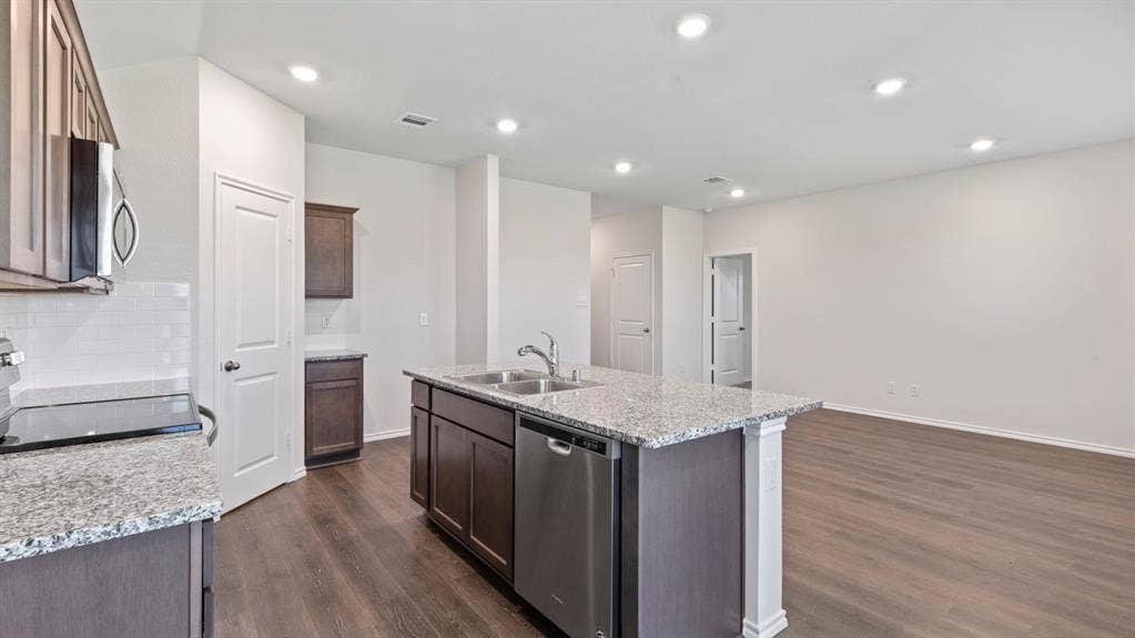 223 Yates Street, Bullard, TX 75757 Kitchen featuring granite countertops, stainless steel appliances, wood-finish flooring, white subway tile backsplash, and recessed lighting