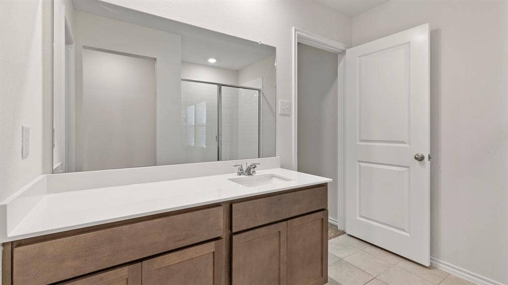 223 Yates Street, Bullard, TX 75757 Bathroom vanity with a white countertop, undermount sink, and chrome faucet