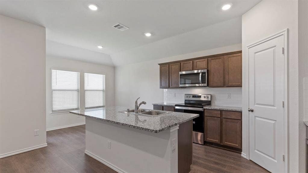 223 Yates Street, Bullard, TX 75757 Kitchen island with granite countertop and dual basin sink