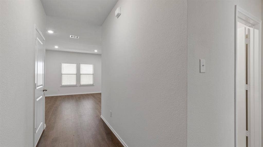 223 Yates Street, Bullard, TX 75757 Hallway featuring wood-finish flooring, recessed lighting, white interior doors, and a neutral wall color