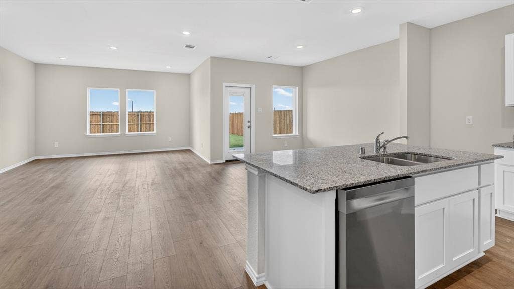 237 Yates Street, Bullard, TX 75757 Open-concept living area with wood-finish flooring, recessed lighting, and ample natural light
