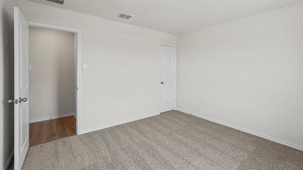 185 Brooks Street, Bullard, TX 75757 Neutral wall paint, carpet flooring, a single paneled door, and a built-in closet