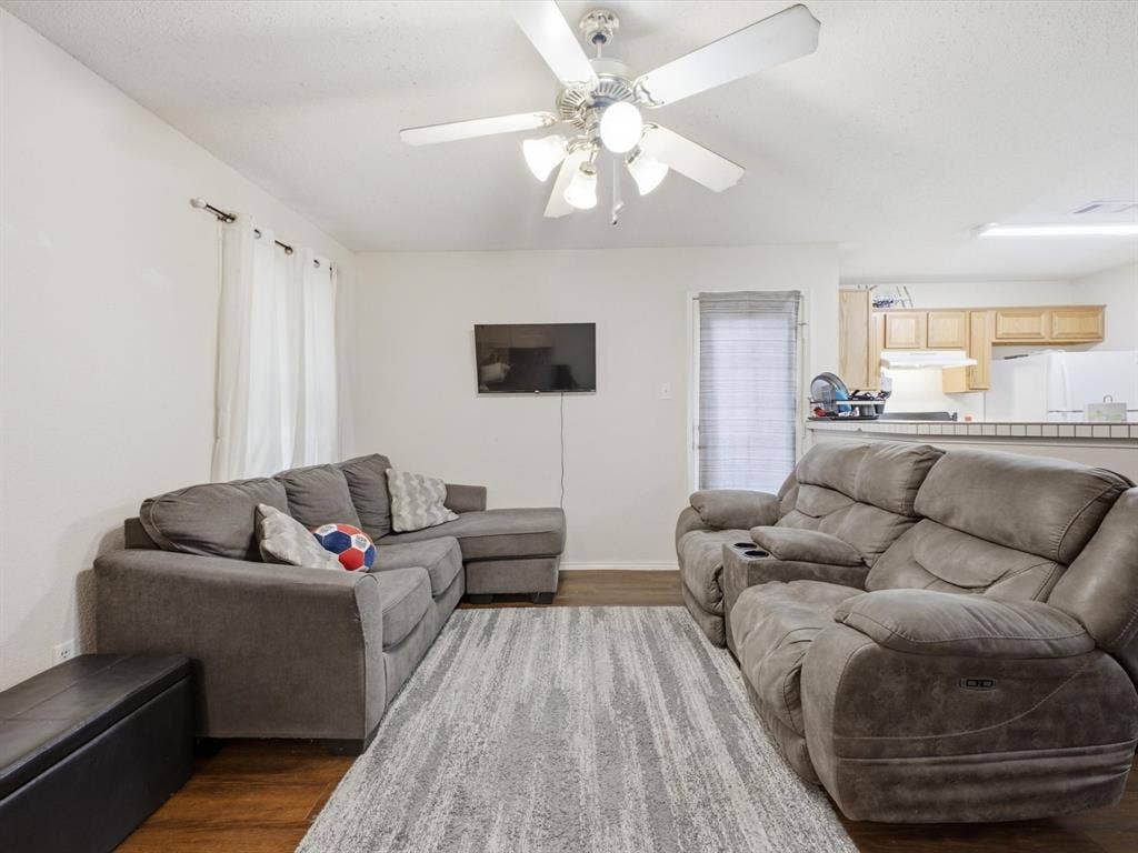 2001 Waleska Plaza, Dallas, TX 75211 Spacious living area featuring wood-finish flooring, ceiling fan with integrated lighting, and white walls