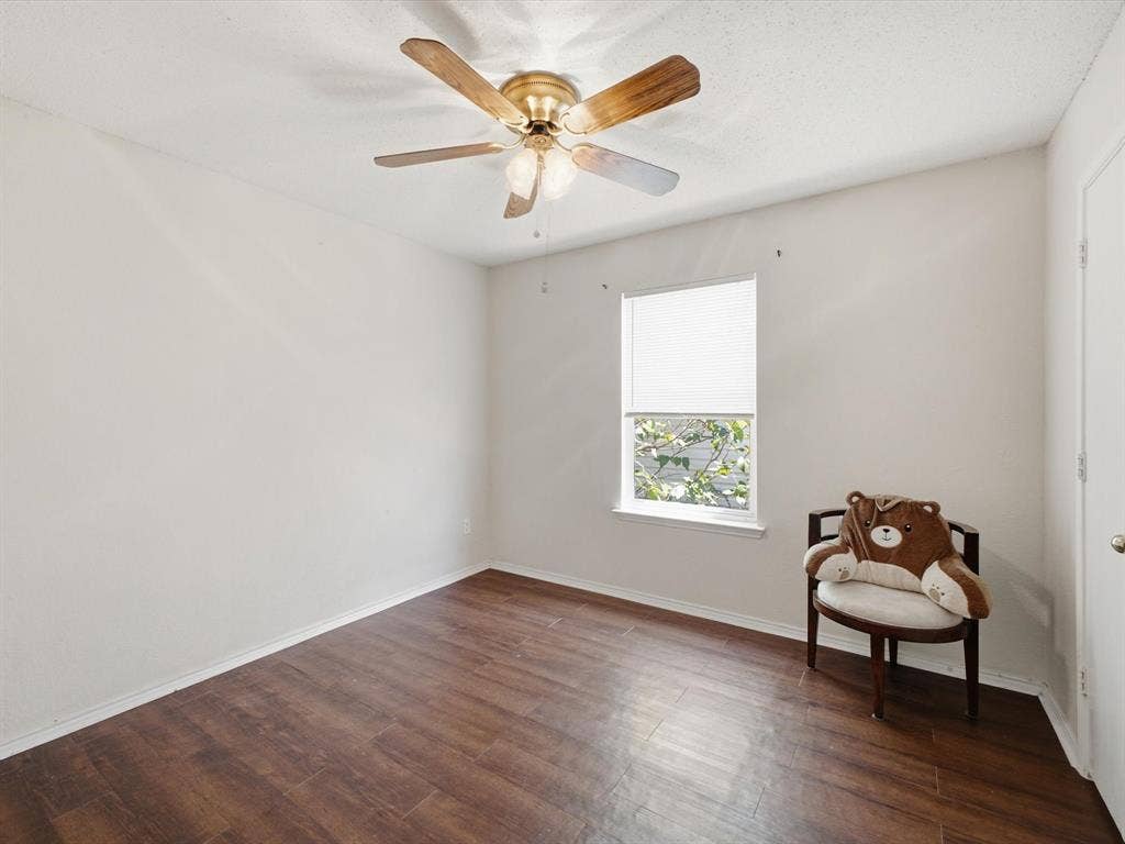 2001 Waleska Plaza, Dallas, TX 75211 Wood-finish flooring, single window with blinds, ceiling fan with integrated lighting, white walls, and a white door