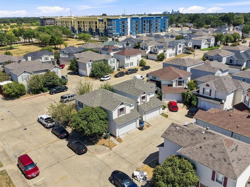 2001 Waleska Plaza, Dallas, TX 75211 Residential neighborhood featuring multiple single-family homes with attached garages, mature trees, and paved roadways