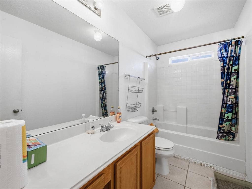 2001 Waleska Plaza, Dallas, TX 75211 Bathroom featuring a vanity with wood-finish cabinetry, a white countertop, and a white sink