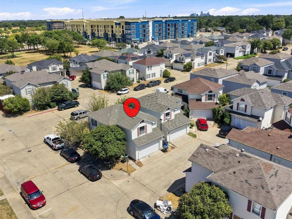 2001 Waleska Plaza, Dallas, TX 75211 Two-story residence with a light-colored exterior and a dark shingle roof