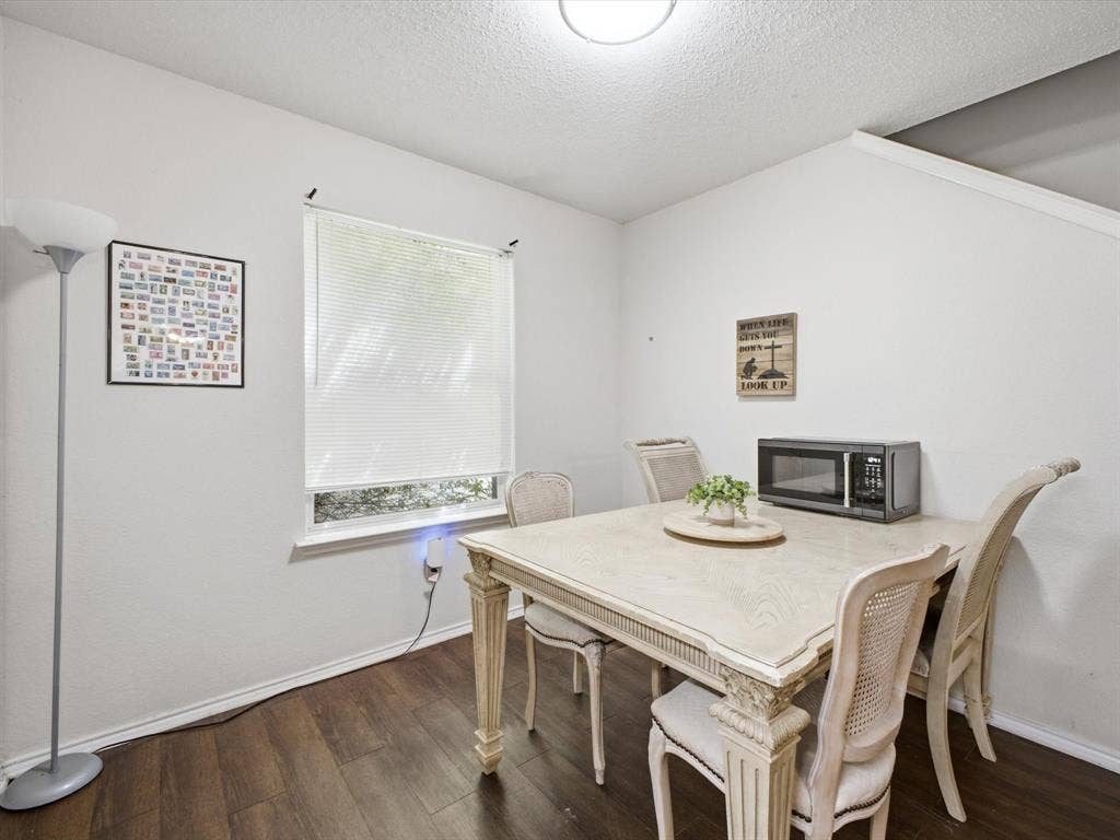 2001 Waleska Plaza, Dallas, TX 75211 Wood-finish flooring, white painted walls, and a window with blinds