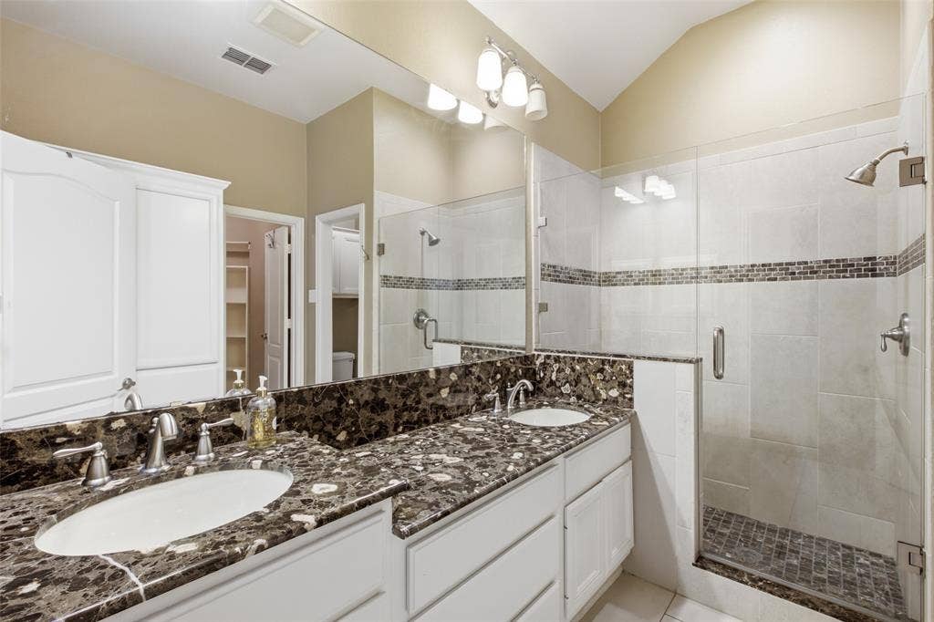 14616 Vintage Lane, Addison, TX 75001 Double vanity with stone-finish countertop, dual undermount sinks, and brushed nickel fixtures