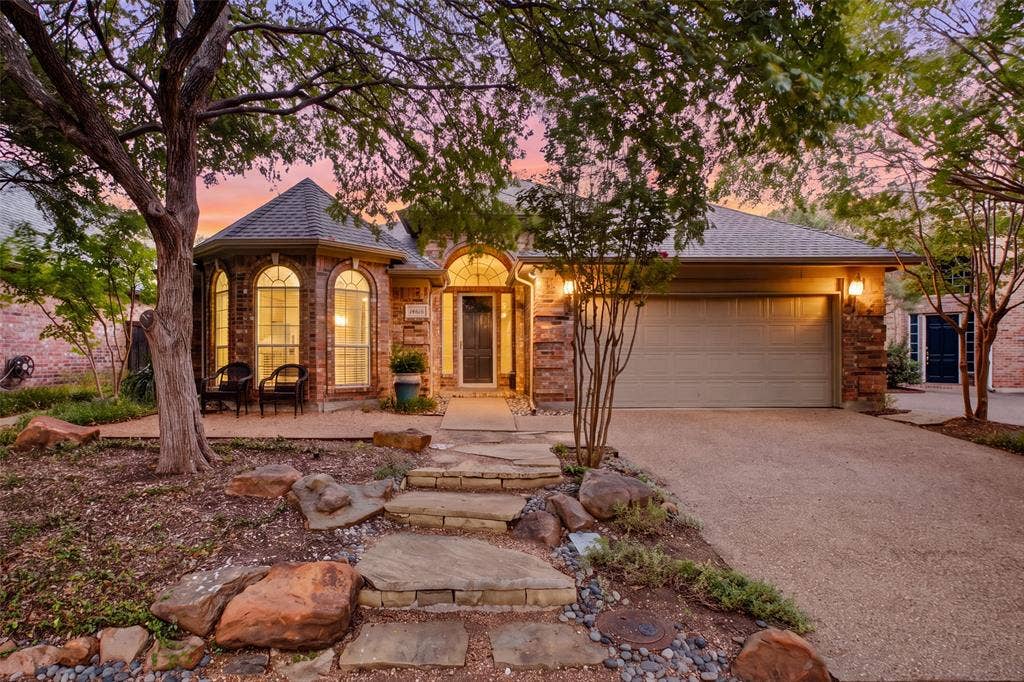 14616 Vintage Lane, Addison, TX 75001 Twilight curb appeal on a quiet Addison street — flagstone walk, mature shade canopy, all bathed in a warm Texas twilight.