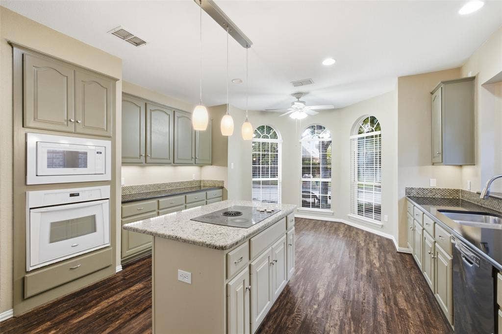 14616 Vintage Lane, Addison, TX 75001 Built-in double oven plus microwave and a full prep island — holiday cooking never bottlenecks here