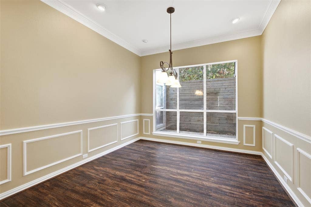 14616 Vintage Lane, Addison, TX 75001 Formal dining in full wainscoting and crown, with a wrought-iron chandelier and garden window