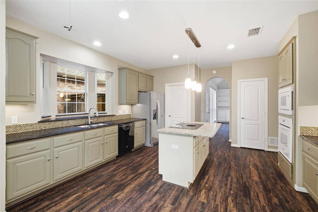 14616 Vintage Lane, Addison, TX 75001 Cabinetry for days: granite counters, glass mosaic backsplash, deep runs of storage on every wall