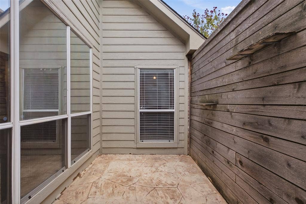 14616 Vintage Lane, Addison, TX 75001 A tucked-away side courtyard in stamped concrete — your own quiet pocket of privacy