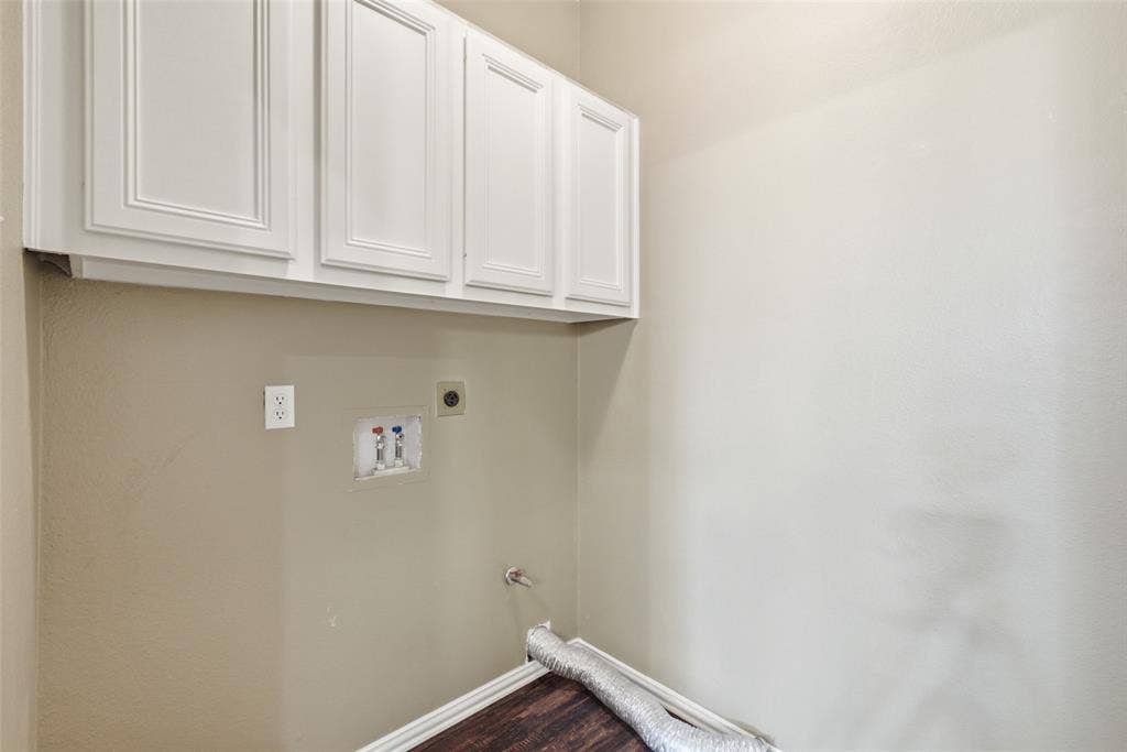 14616 Vintage Lane, Addison, TX 75001 Dedicated laundry room with overhead cabinetry and full-size washer/dryer connections