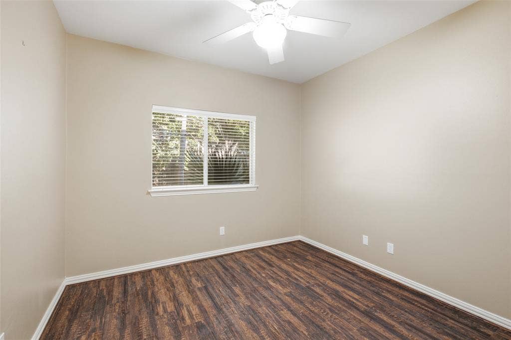 14616 Vintage Lane, Addison, TX 75001 Peaceful third bedroom looking out on mature landscaping — quiet enough for a work-from-home desk