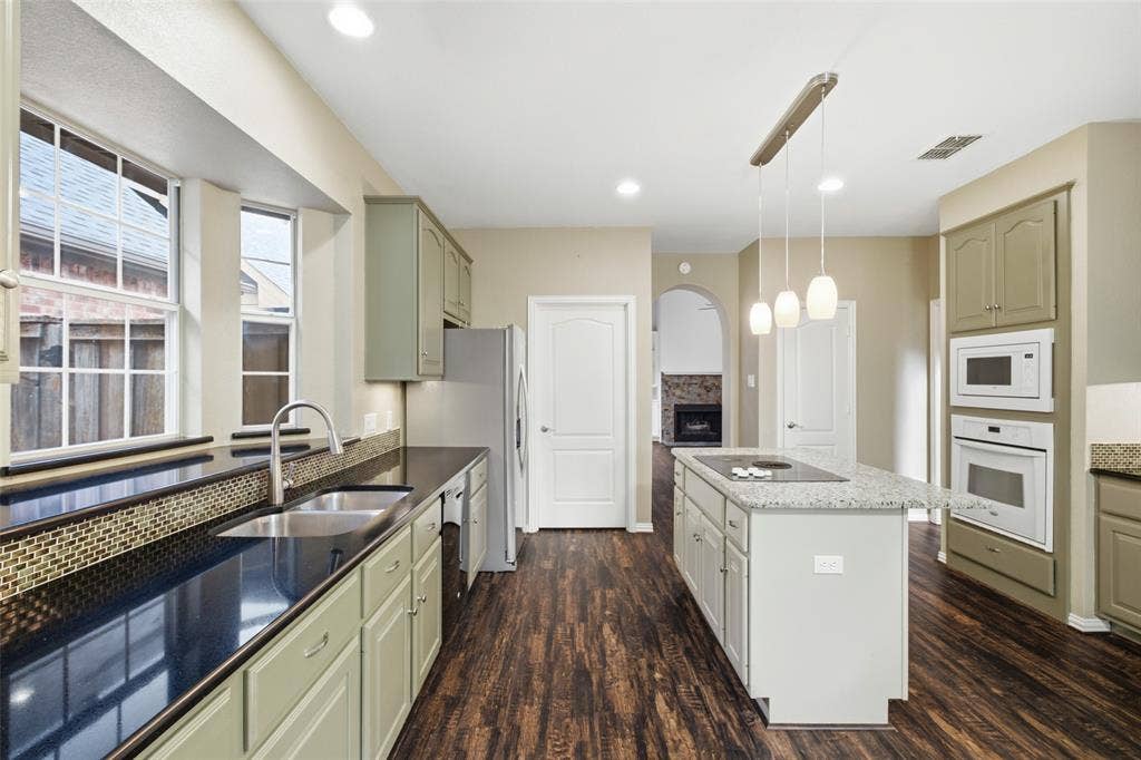 14616 Vintage Lane, Addison, TX 75001 Stand at the sink and still see the fireplace — the cook is never stuck in another room