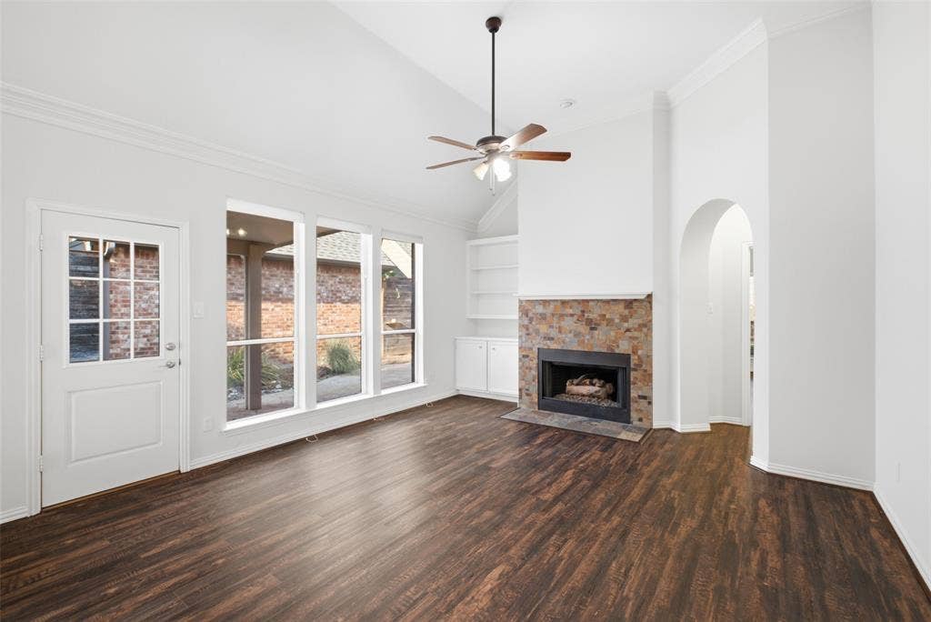 14616 Vintage Lane, Addison, TX 75001 Wall of windows to the patio and a fireplace that anchors the room — light all day, warmth all winter