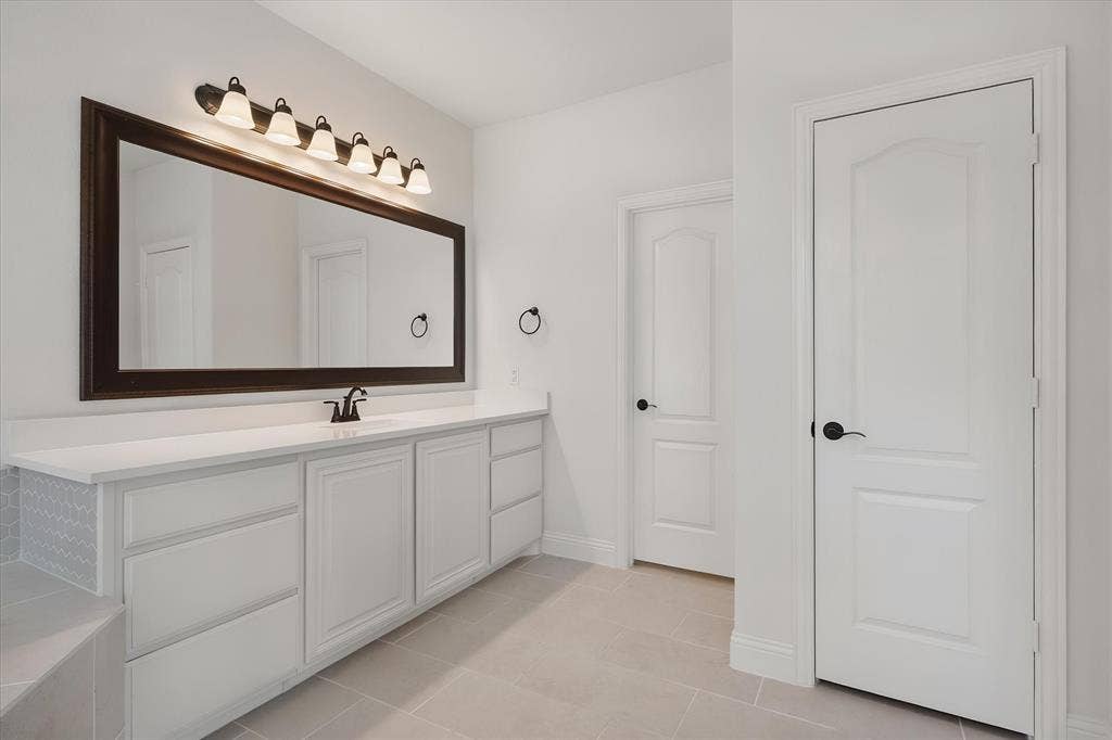 5626 Rutherford Drive, Midlothian, TX 76065 Here's the second vanity — plenty of counter and drawer space, plus doors leading to the water closet (private toilet door) and closet.