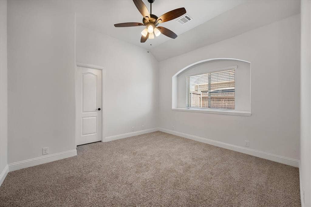 5626 Rutherford Drive, Midlothian, TX 76065 Soft carpet under your feet, a cozy arched window nook, and that vaulted ceiling makes it feel way bigger than a typical bedroom.