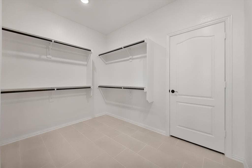 5626 Rutherford Drive, Midlothian, TX 76065 The primary walk-in closet — double hanging rods on both walls, so there's room for every season's wardrobe.
