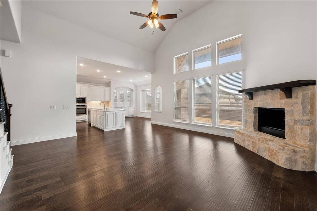5626 Rutherford Drive, Midlothian, TX 76065 The living room with it's vaulted ceilings and natural lighting opens up into the kitchen area.