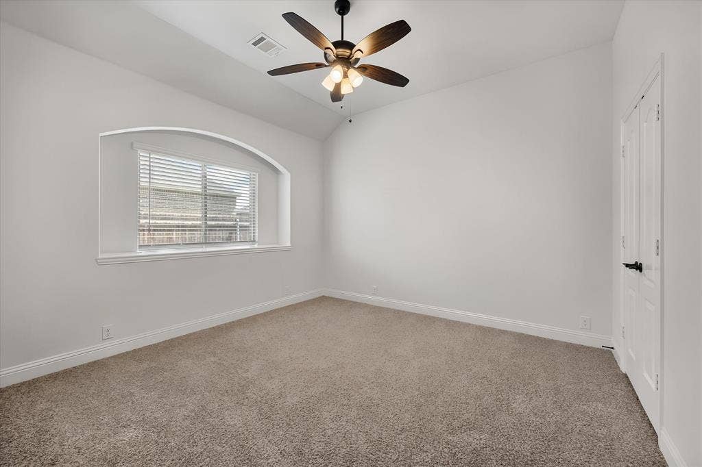 5626 Rutherford Drive, Midlothian, TX 76065 Another great bedroom on this level — I love that arched window, it's such a nice architectural touch, and there's a big closet just to the right for all your storage needs.